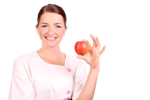 Nurse holding up an apple